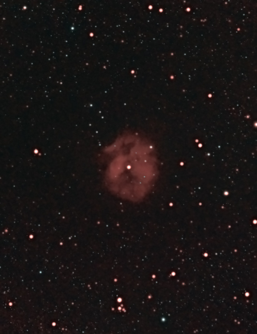 The Cocoon Nebula (IC 5146) photographed from Lakeway, Texas with a ZWO Seestar S50 — a small rounded glow of red hydrogen around a bright central star, with dark dust lanes across its upper half, centered in a dense Cygnus star field.