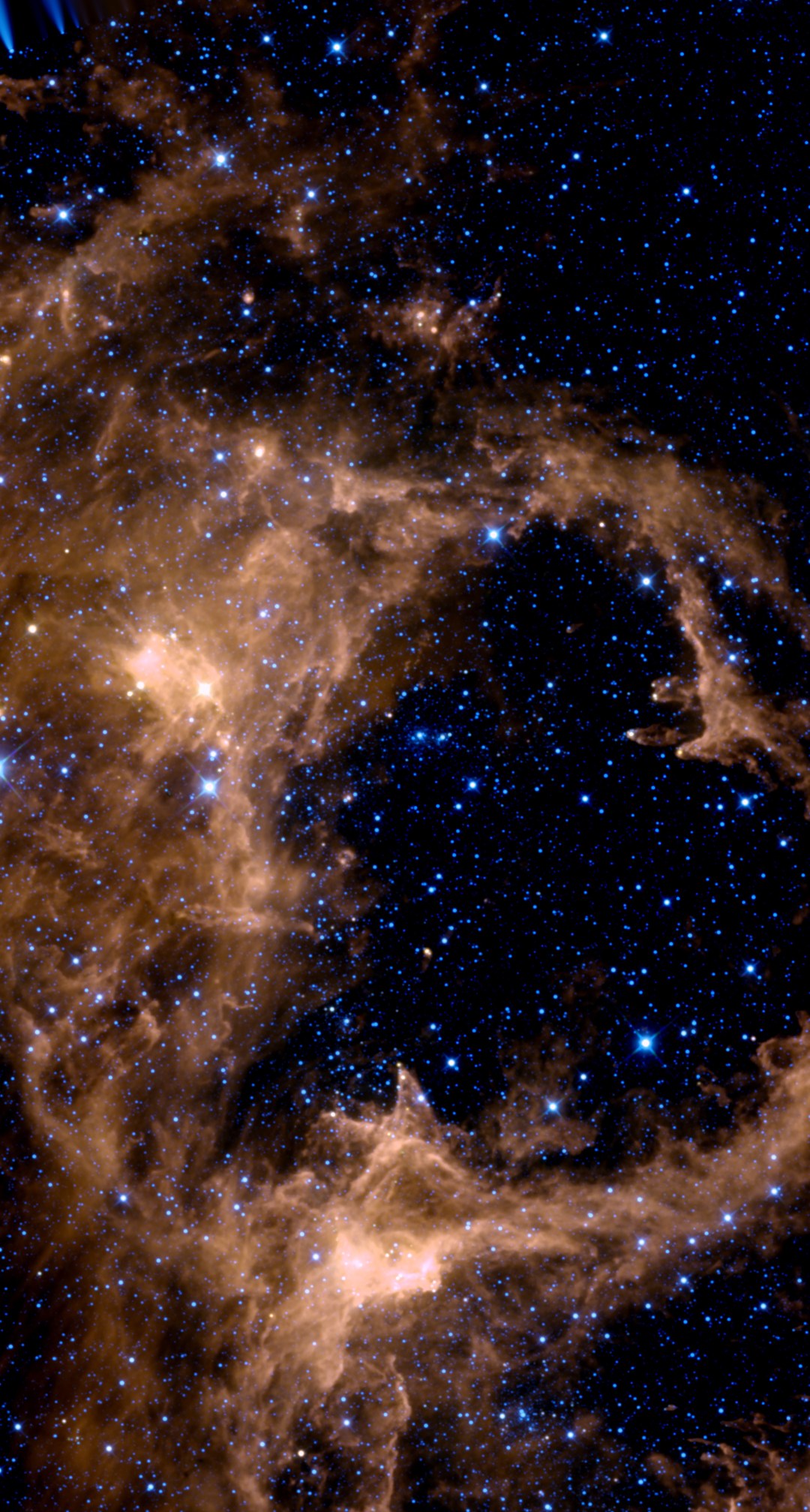 The Soul Nebula in infrared from NASA WISE data, placed on the same framing as the backyard photo — a ring of warm orange dust wrapped around a dark, star-filled cavity, with the brightest dust knots on the bubble wall.