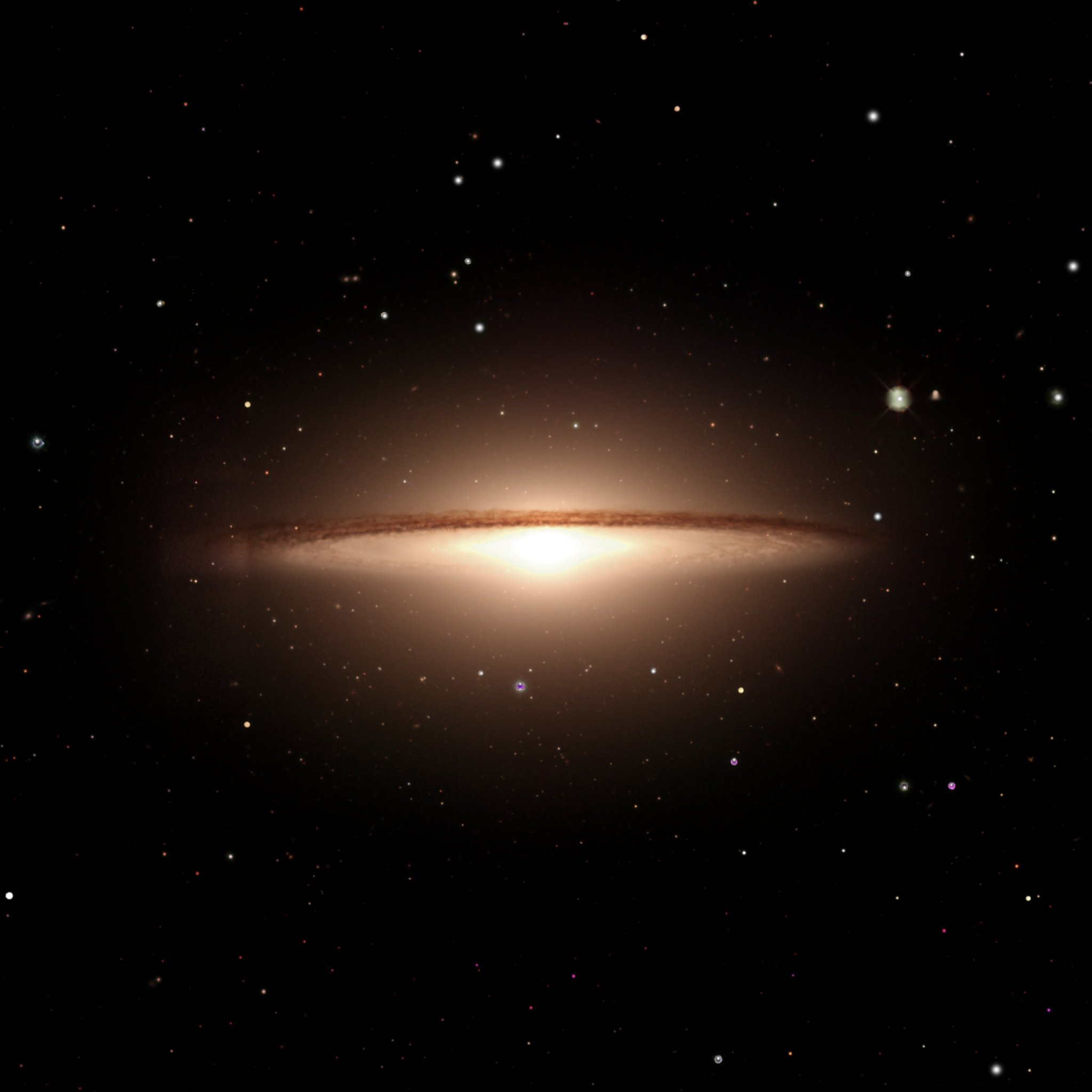 The Sombrero Galaxy (M104) from DESI Legacy Survey data reprocessed by Kyle Eberly — a warm glowing bulge and vast halo bisected by a crisp brick-red dust ring, over a field of background stars.
